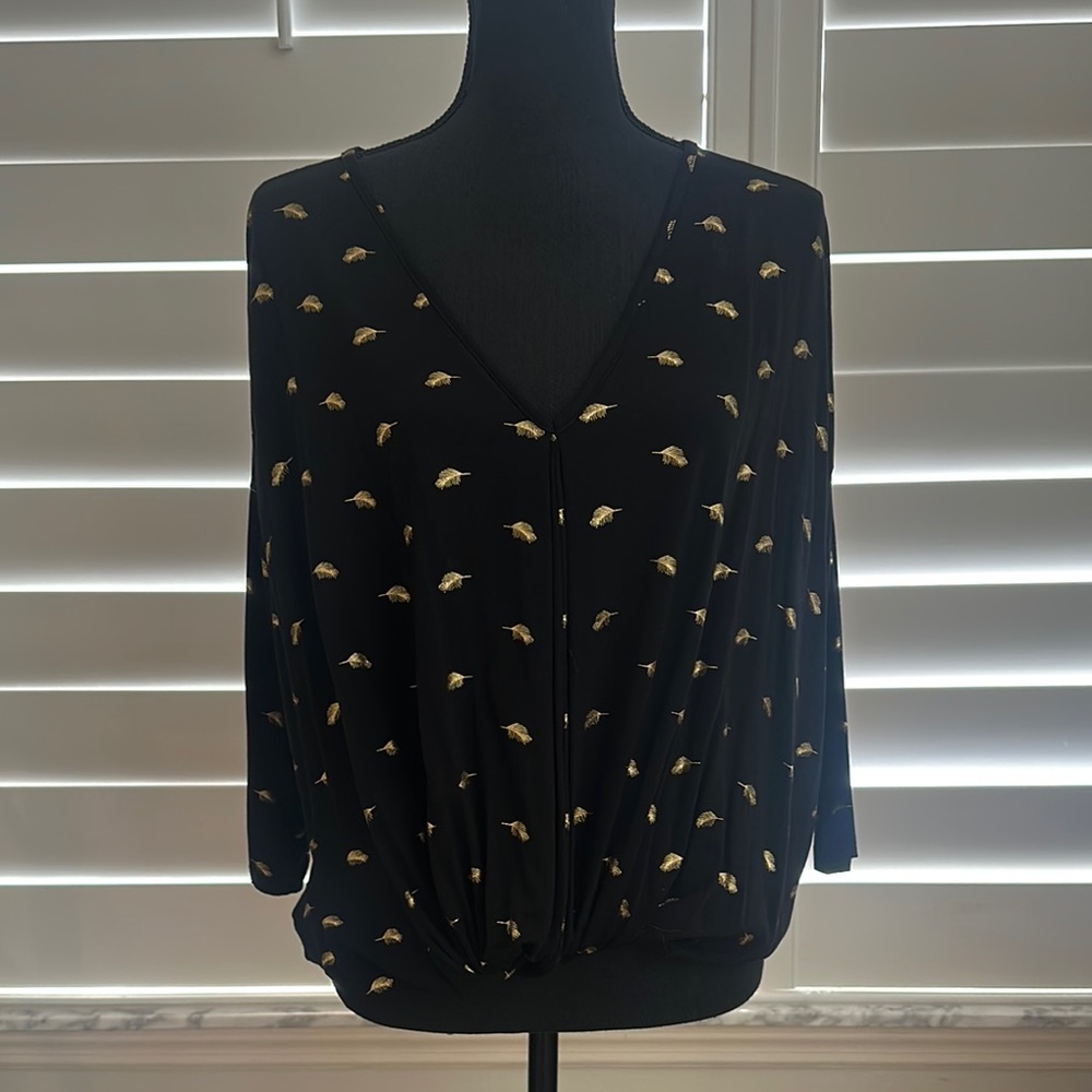 Black top with gold leaf detail
